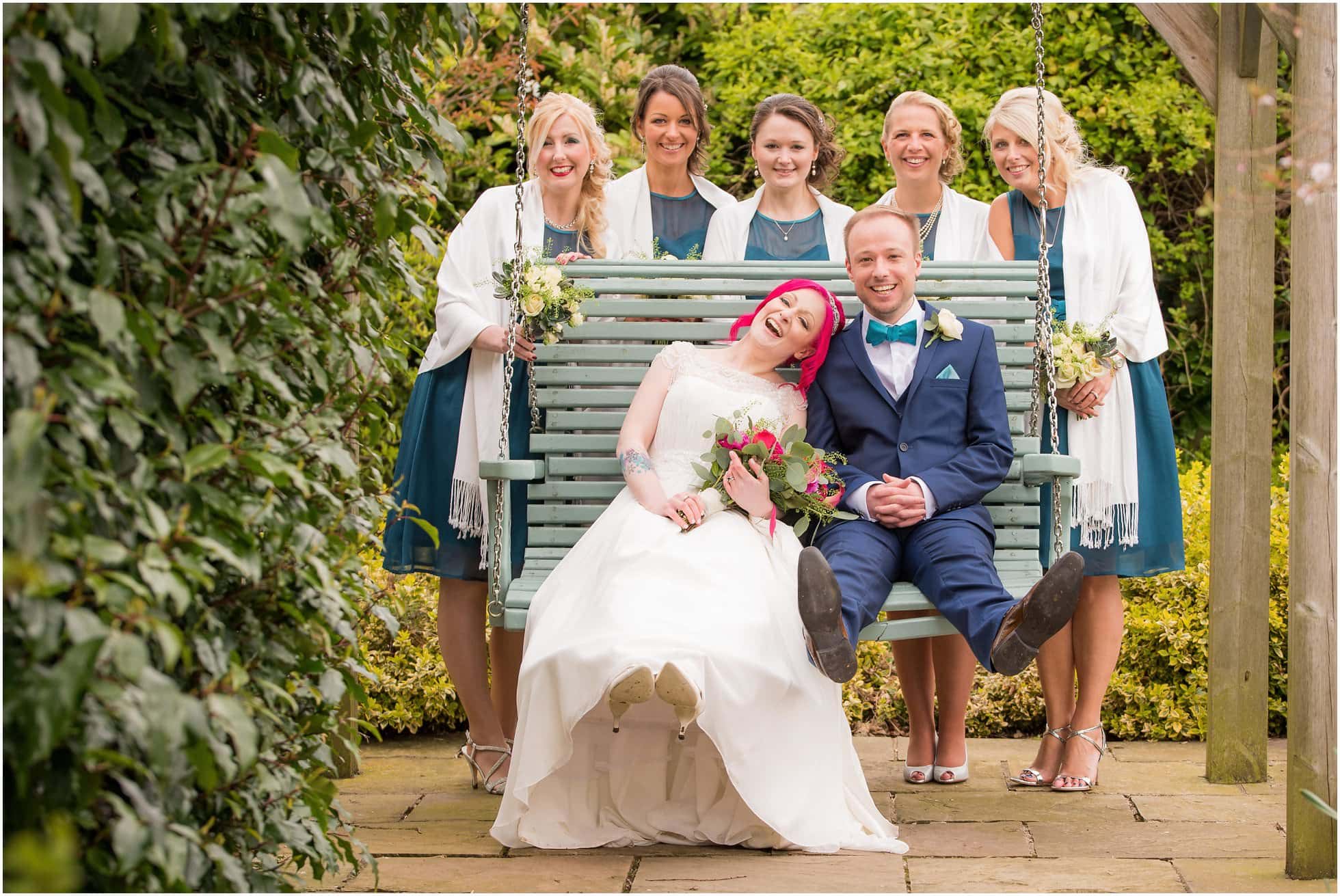 Bridesmaids photo on the swing in the wedding garden