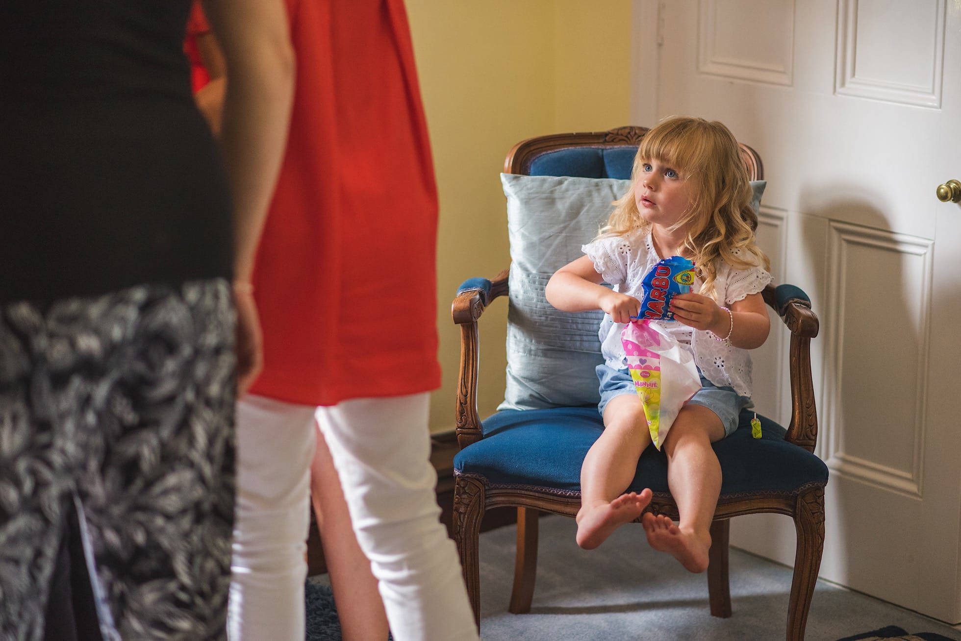 Little girl having sweets in the bridal cottage