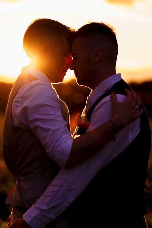 Gay couple enjoying the sunset at a Norfolk Wedding