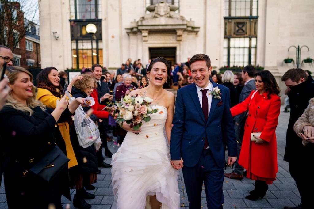 Wedding couple having confetti thrown on them outside Islington Town Hall