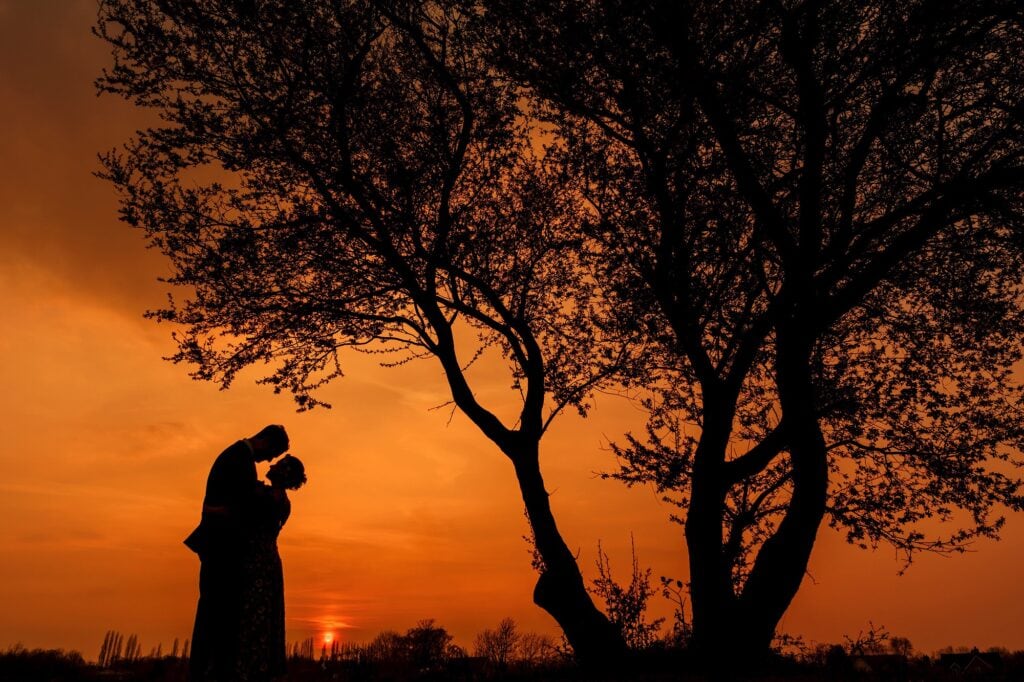 Silhouette photo of couple at sunset