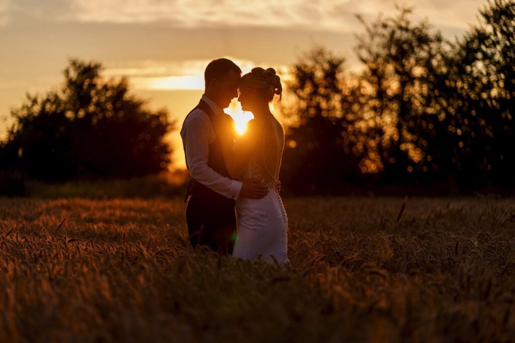 couple at sunset in wheat field