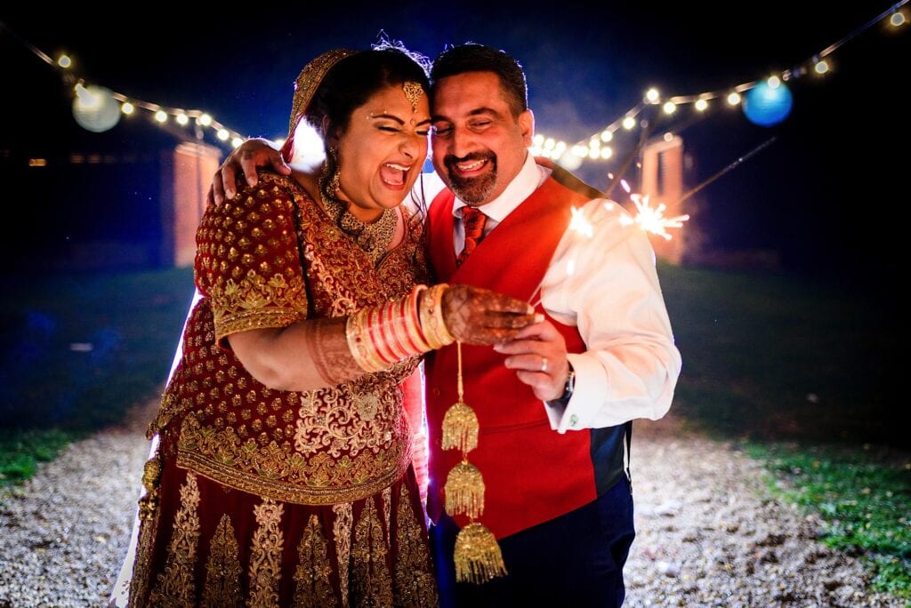 Indian wedding couple holding sparklers