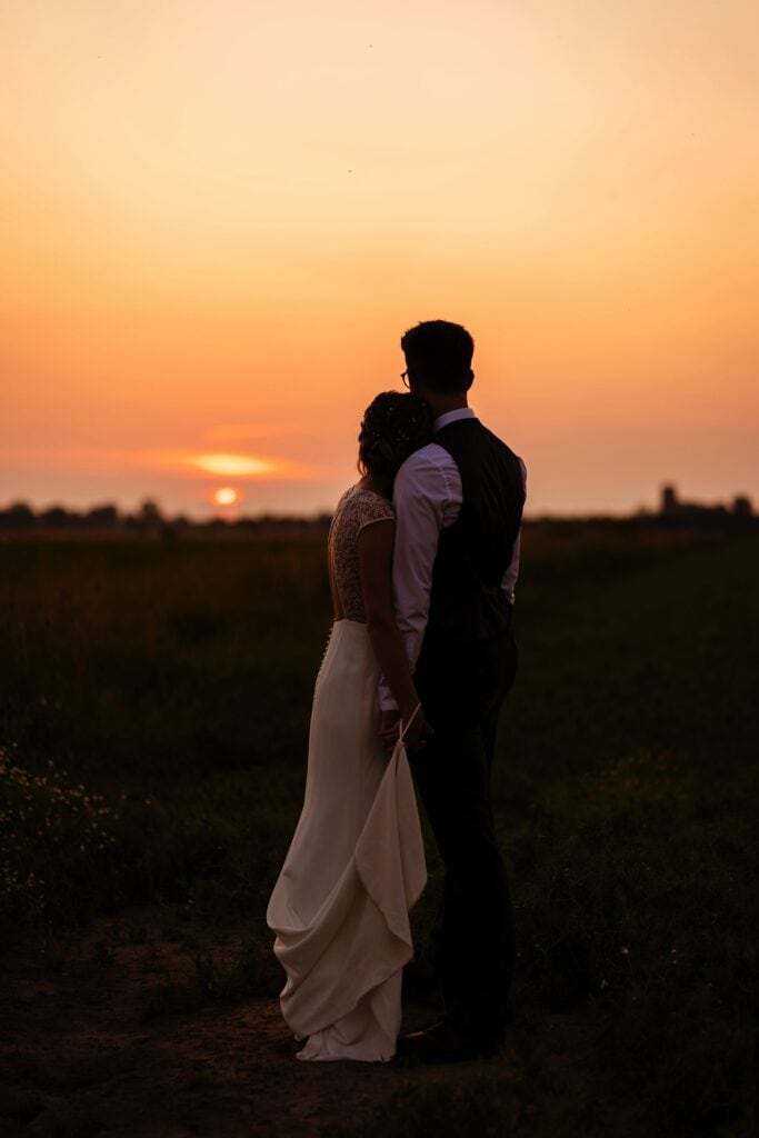 Couple watching the sunset over Norfolk fields