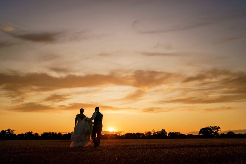 Couple walking towards a beautiful sunset