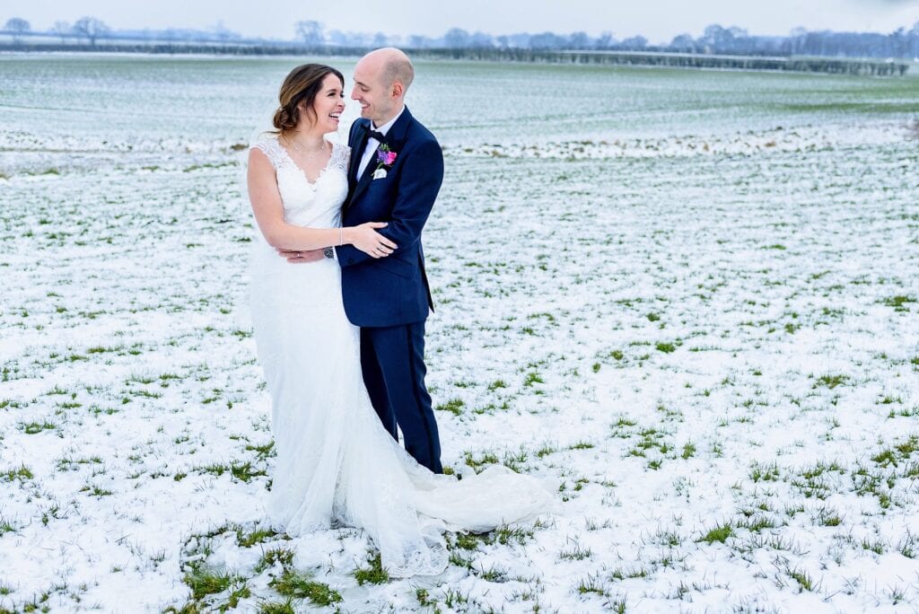 Winter wedding - couple in snowy field