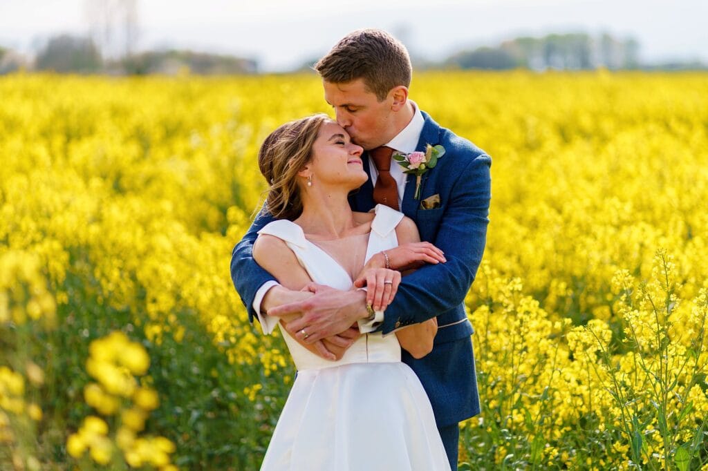 Wedding couple in rapeseed field