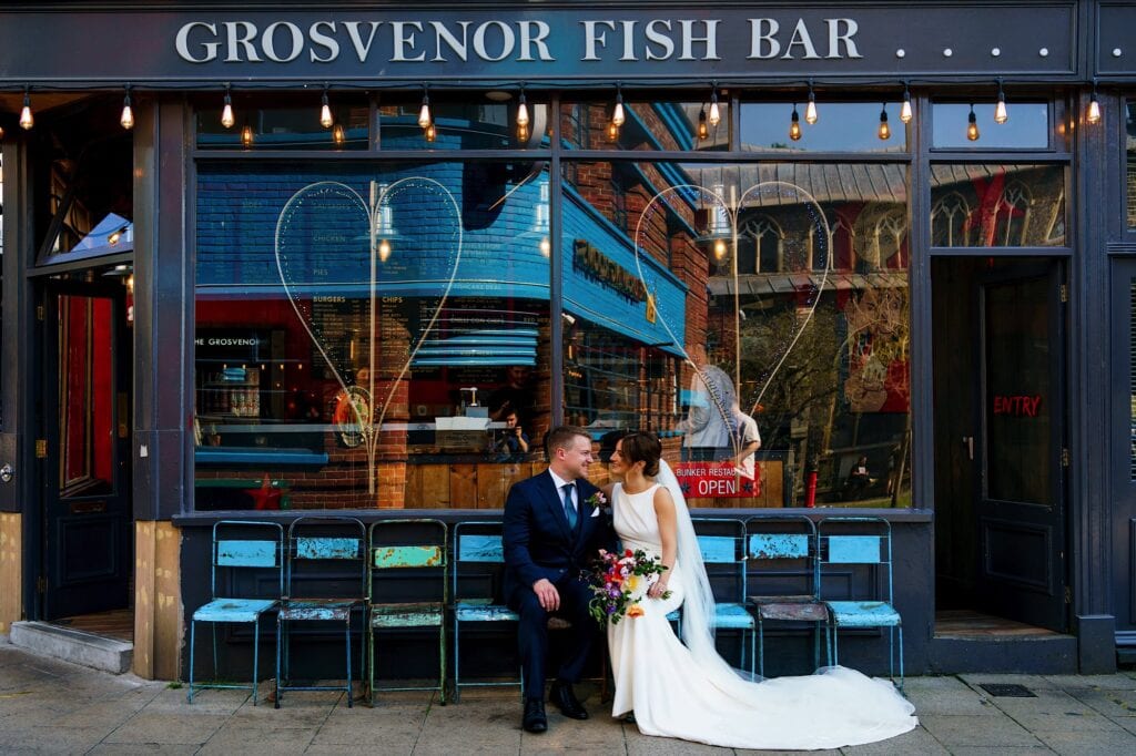 Bride and groom in front of Grosvenor Fish Bar, Norwich