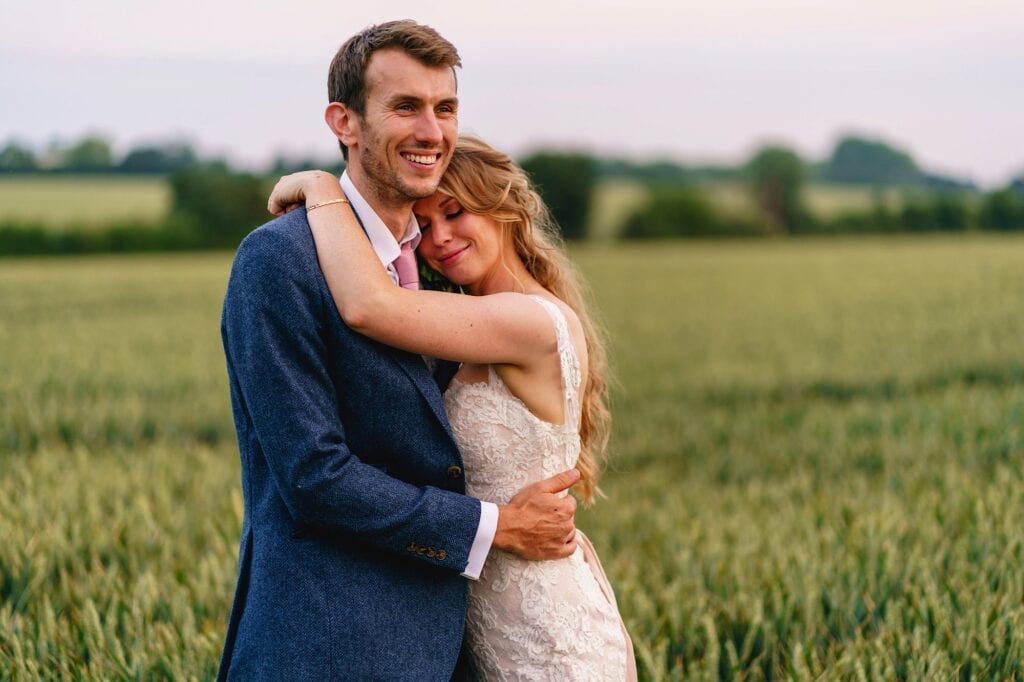 Wedding couple hugging in a wheat field