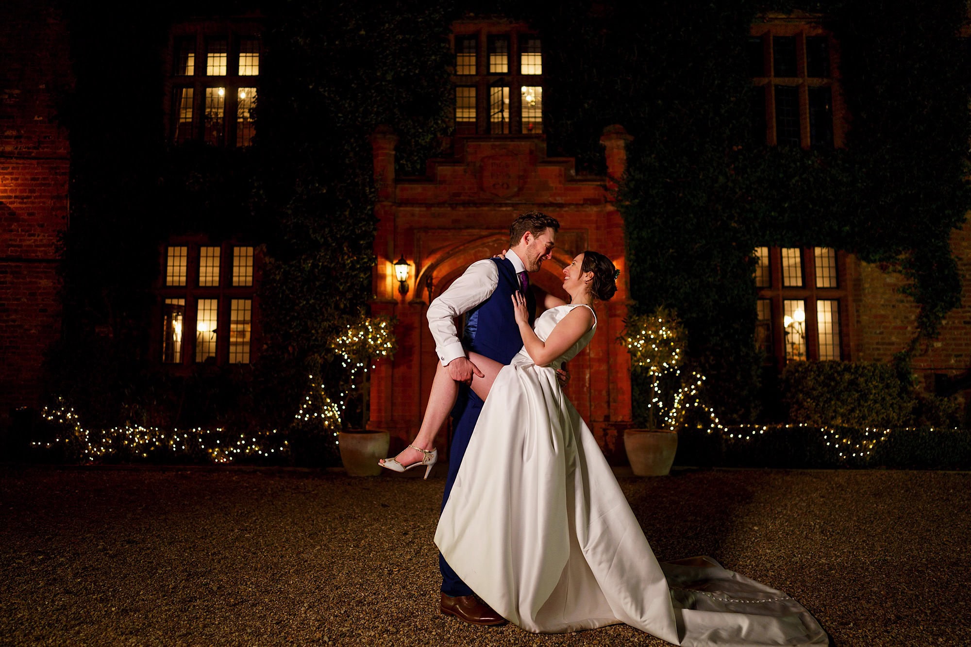 Woodhall Manor Wedding Photographer photo of wedding couple at night in front of the manor house