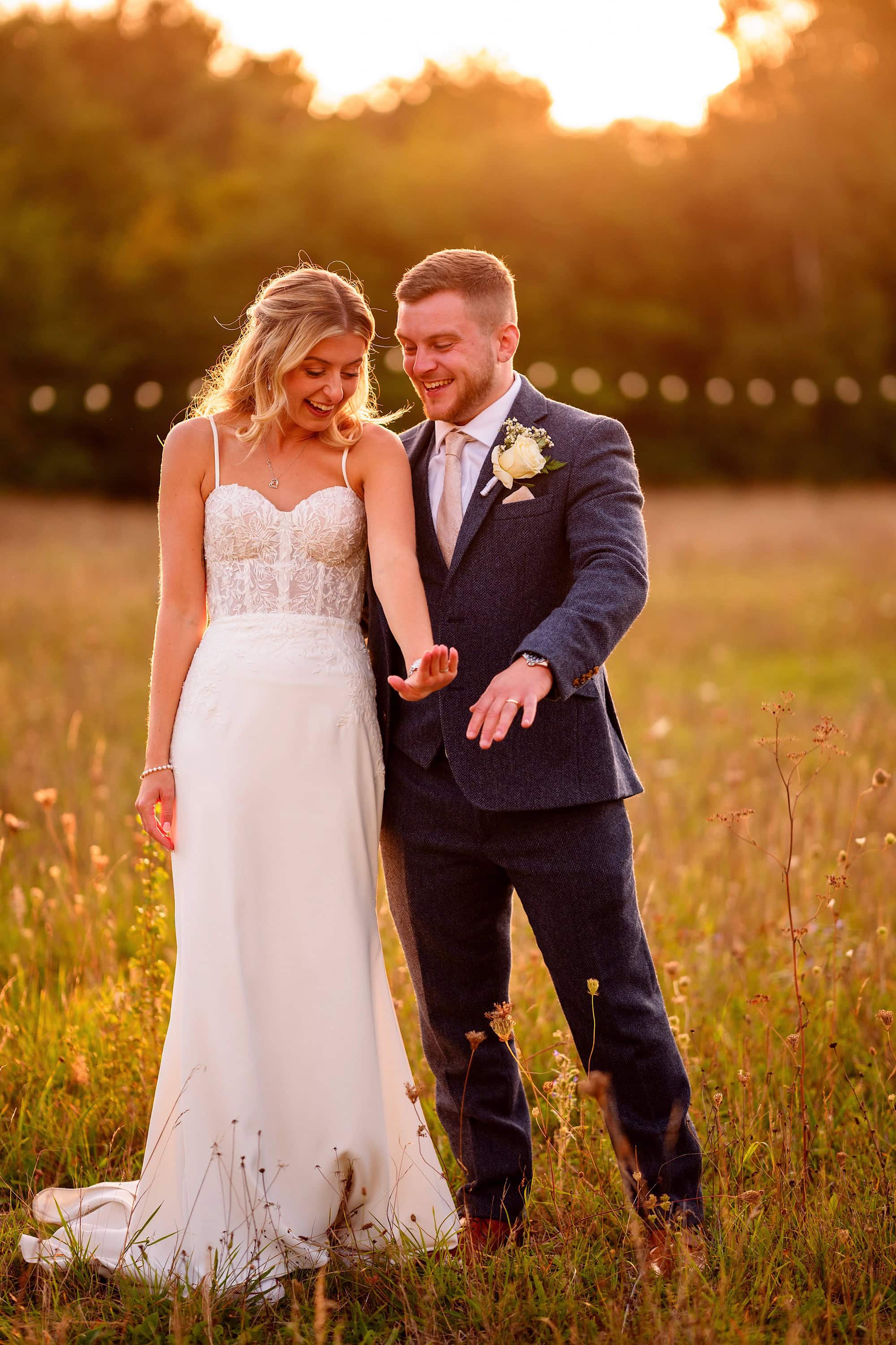 bride and groom looking at their wedding rings