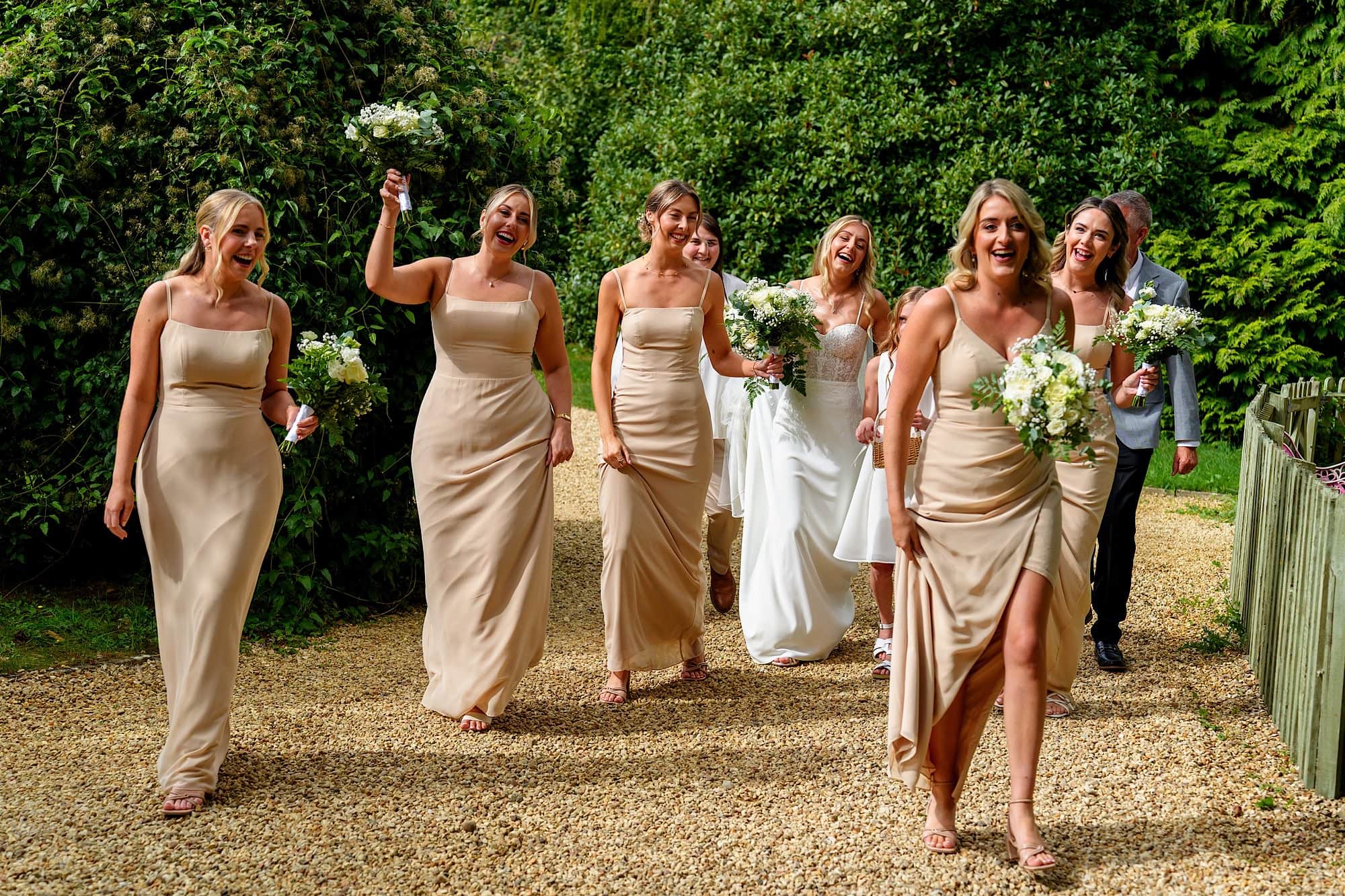 Happy bridal party walking to the ceremony singing