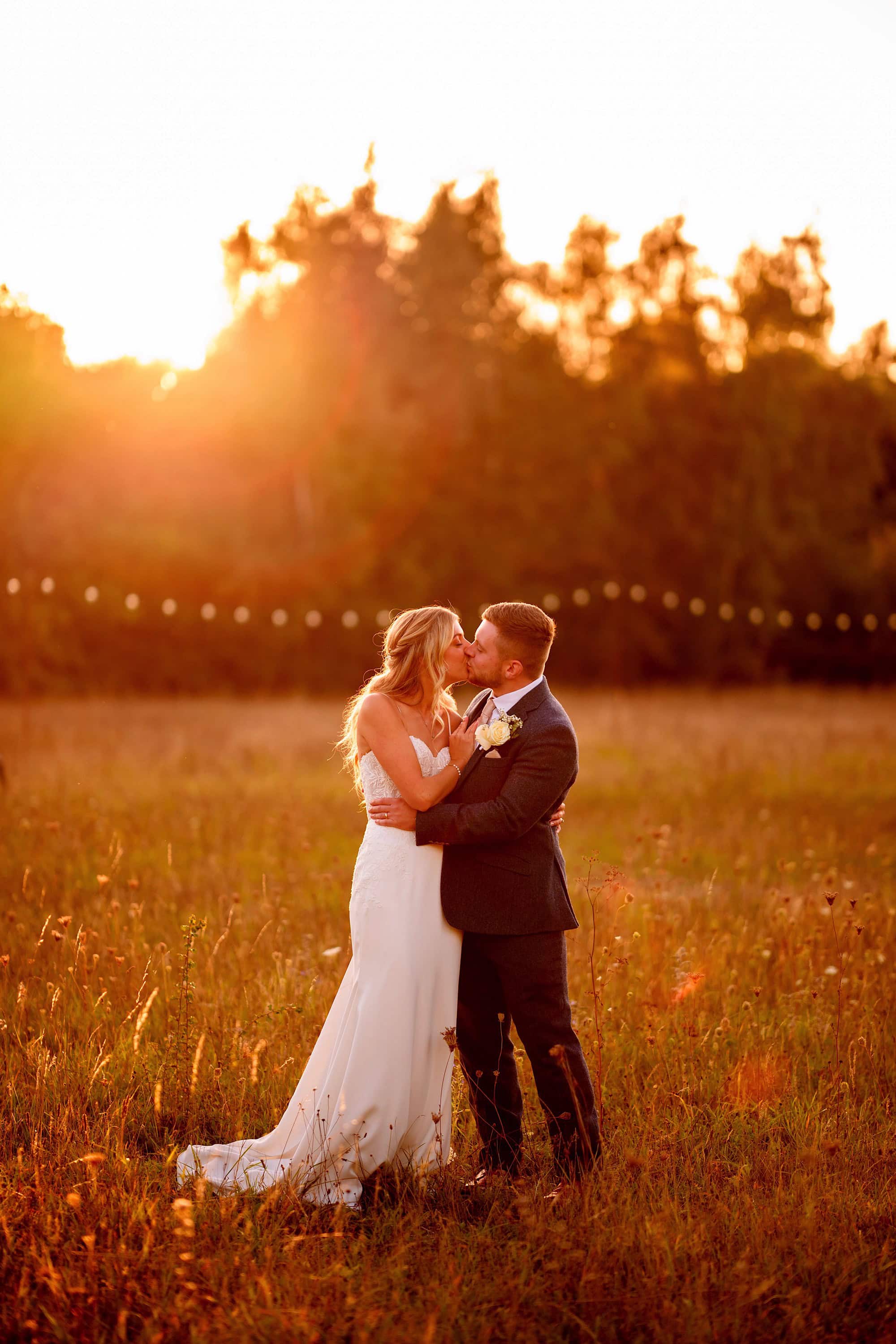 Romantic wedding photo at sunset in a meadow