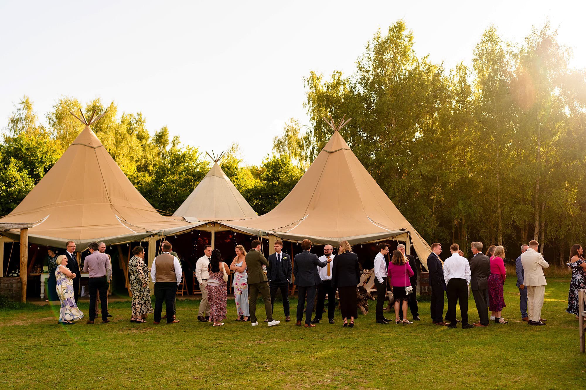 wellington wood tipi with guests lining up for wedding breakfast