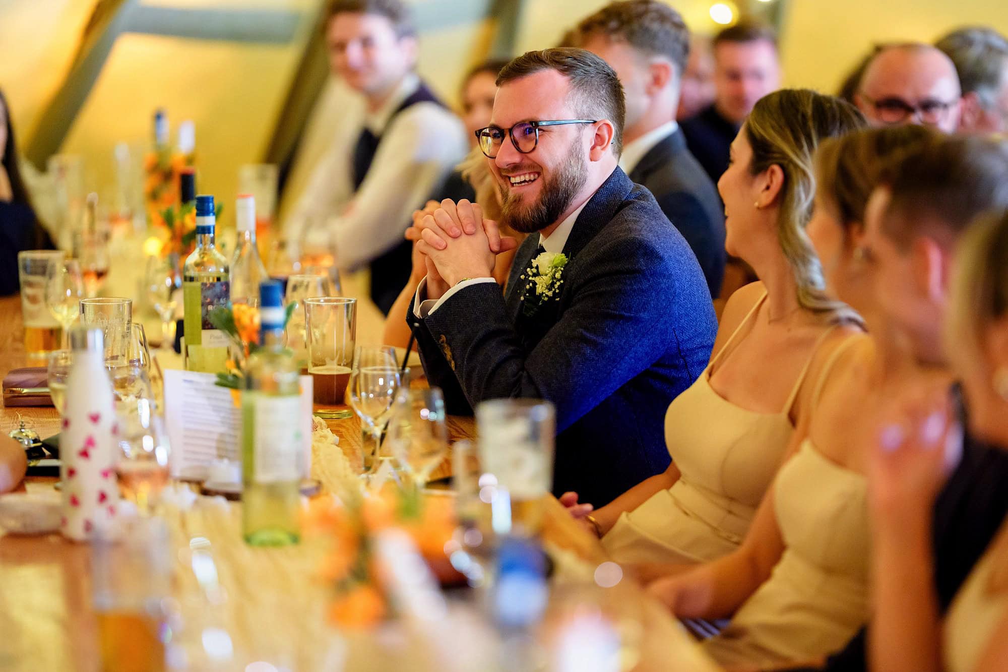 best man smiling during speeches