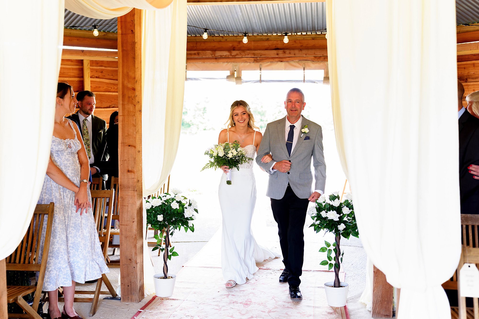 father of the bride walking the bride down the aisle in the larch at wellington wood